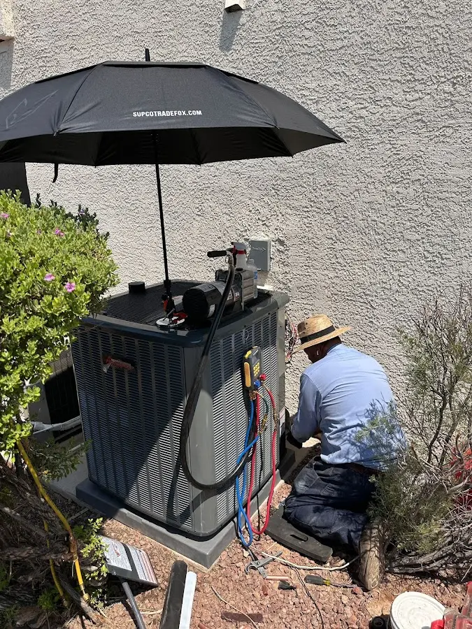 HVAC technician performing outdoor AC maintenance in Lehman